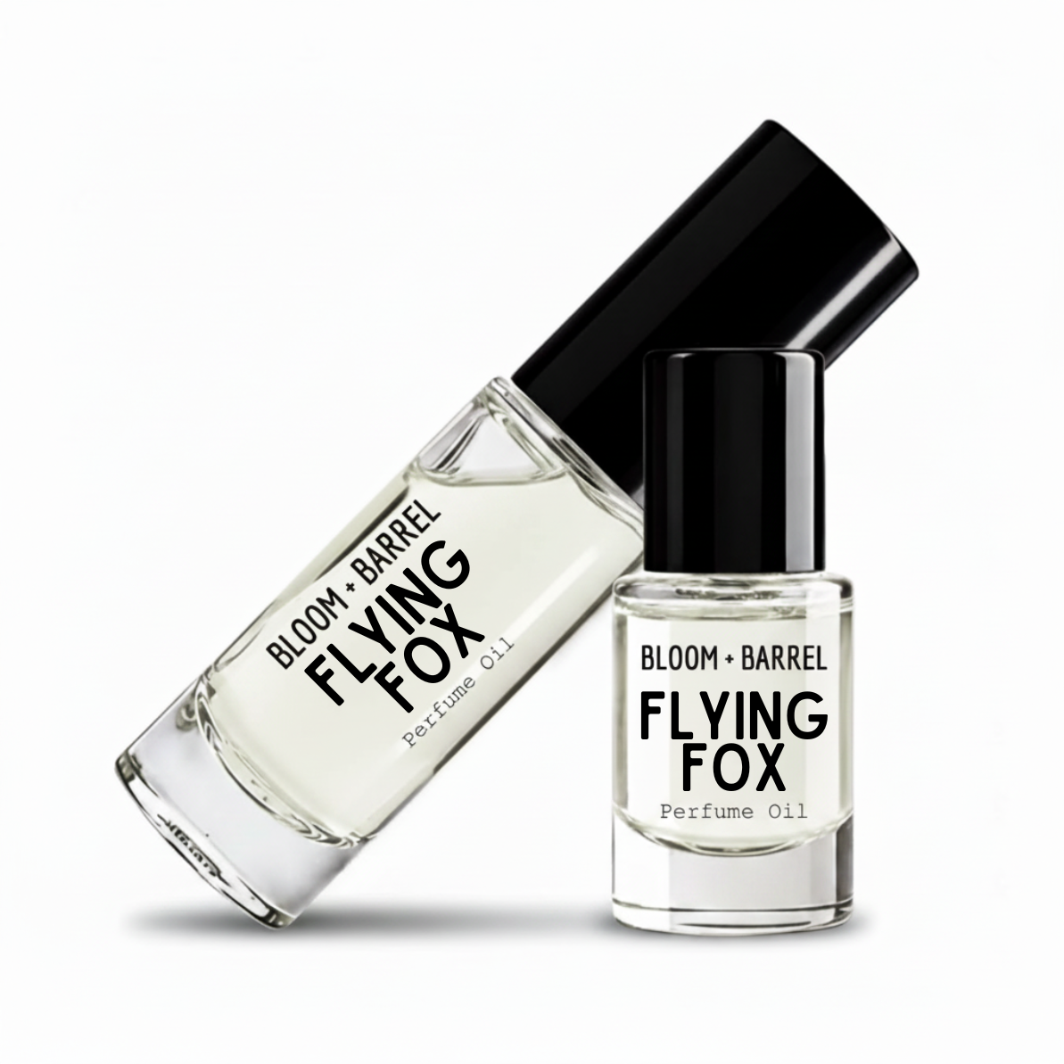 Two clear glass bottles of Bloom + Barrel flying fox perfume oil with black caps, one roll-on bottle and one perfume oil bottle, on a white background.