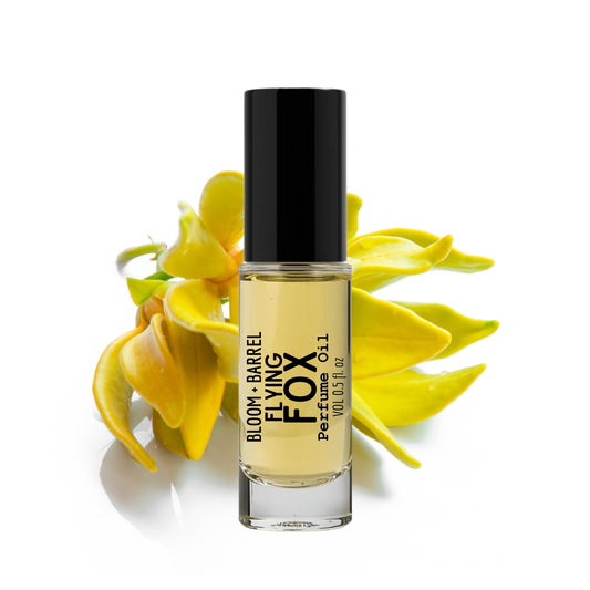 Perfume bottle labeled 'Bloom Barrel Flying Fox' with yellow flowers on a white background