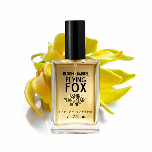 Perfume bottle labeled 'Flying Fox' with yellow flowers on a white background
