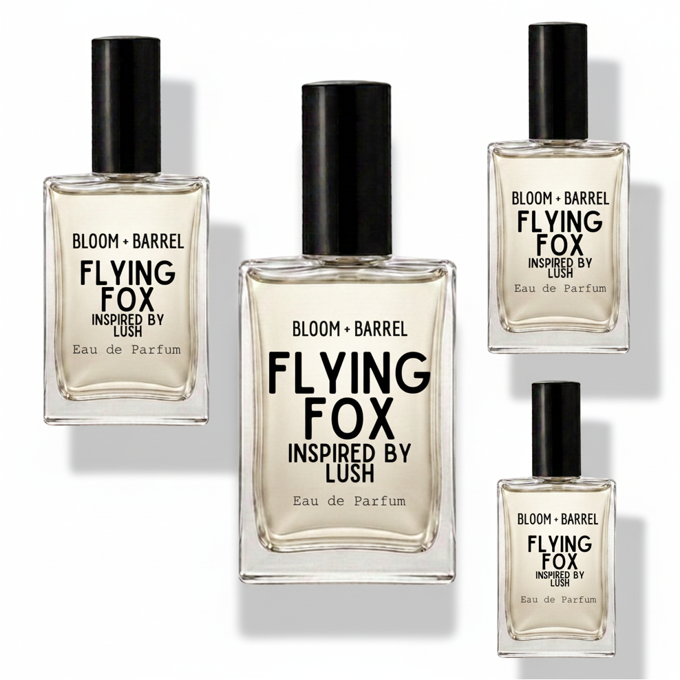 Four clear glass perfume bottles with black caps arranged on a white background. The center bottle is largest, with three smaller matching bottles around it.
