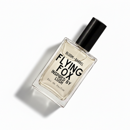 A rectangular glass perfume bottle with a black cap, containing a pale amber liquid. The front label reads 'BLOOM • BARREL FLYING FOX INSPIRED BY LUSH Eau de Parfum' in black text, set against a plain white background.