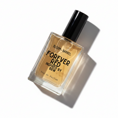 A rectangular glass bottle of Forever Red Eau de Parfum by BBW, filled with amber-colored liquid and featuring a black cap, centered on a plain white background.