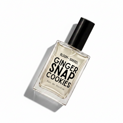 A rectangular glass bottle of Bloom Barrel Ginger Snap Cookies Eau de Parfum with a black cap, centered on a plain white background.