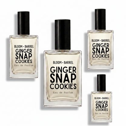 Four glass bottles of Bloom + Barrel Ginger Snap Cookies Eau de Parfum with black caps, arranged on a plain white background.