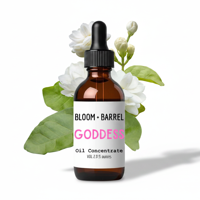 Bottle of Bloom + Barrel Goddess Oil Concentrate with flowers on a white background