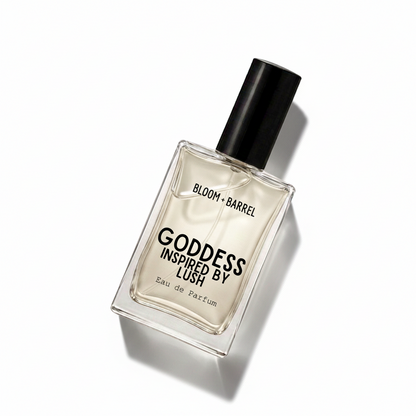 A rectangular glass perfume bottle with a black cap, containing a pale amber liquid. The front label reads 'BLOOM • BARREL' and 'GODDESS INSPIRED BY LUSH' with 'Eau de Parfum' below, set against a plain white background.