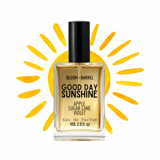 Perfume bottle labeled 'Good Day Sunshine' with a sun graphic in the background