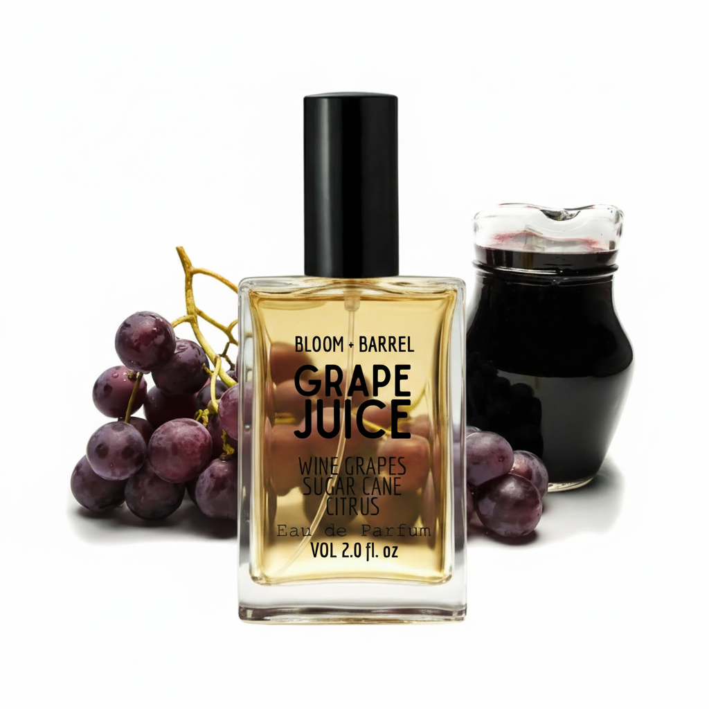 Bloom + Barrel Grape Juice Eau de Parfum bottle in the center, flanked by a bunch of purple grapes on the left and a dark glass jar on the right, all on a white background.