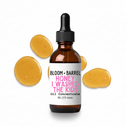 Bottle of 'Bloom + Barrel Honey I Washed the Kids' oil concentrate with dropper on a white background.