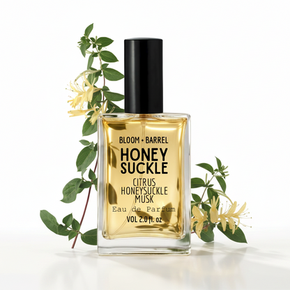 Perfume bottle labeled 'Honey Suckle' with a sprig of honeysuckle on a white background