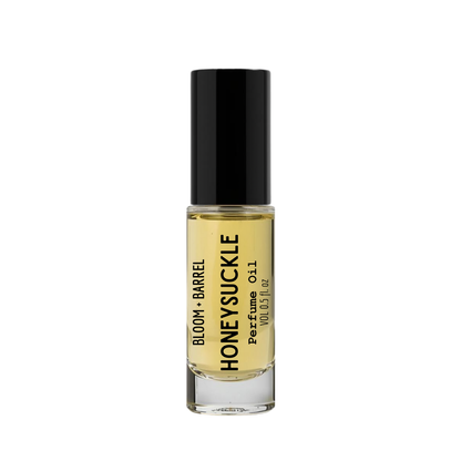 Perfume bottle labeled 'Honeysuckle' by Bloom & Barrel on a white background