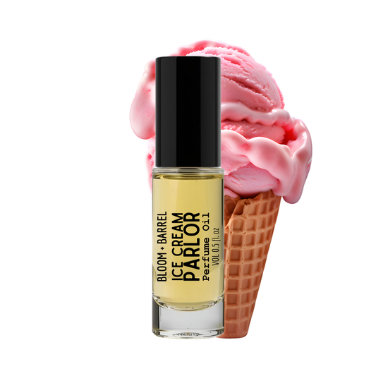 Perfume bottle labeled 'Ice Cream Parlor' next to a pink ice cream cone on a white background