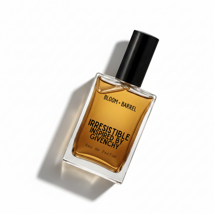 A rectangular glass bottle of Givenchy Bloom + Barrel Irresistible Eau de Parfum with amber-colored liquid, a black cap, and black lettering on a white background.