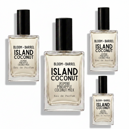 Four glass perfume bottles of BLOOM + BARREL Island Coconut Eau de Parfum with black caps, arranged on a plain white background.