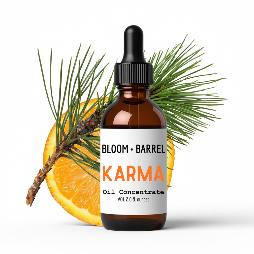 Bottle of Bloom & Barrel Karma oil concentrate with an orange and pine branch on a white background