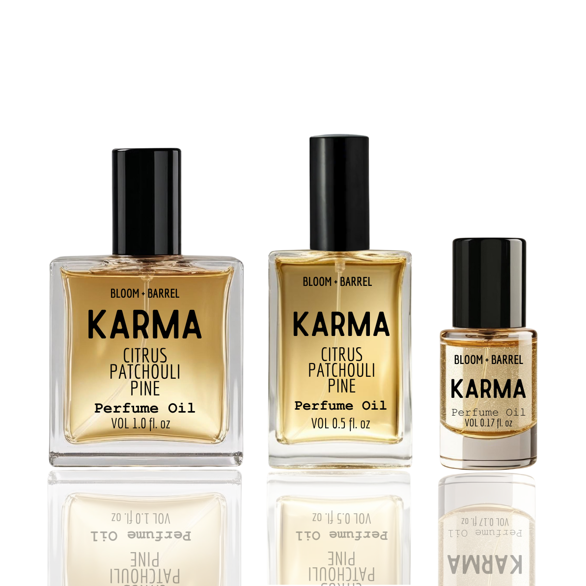 Three bottles of Karma perfume oil by Bloom & Barrel on a white background
