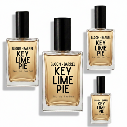 Four bottles of Bloom + Barrel Key Lime Pie Eau de Parfum arranged on a plain white background, with varying bottle sizes but all showing the same amber liquid, black caps, and black text labels.