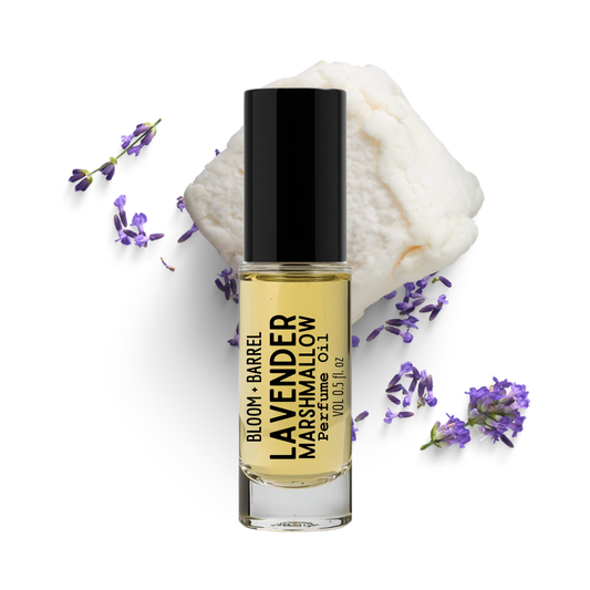Bottle of Lavender Barrel Marshmallow perfume with lavender flowers on a white background