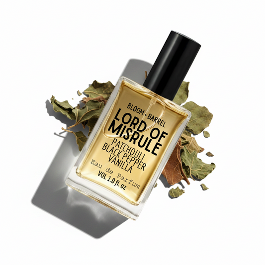 Perfume bottle labeled 'Lord of Misrule' with leaves on a white background