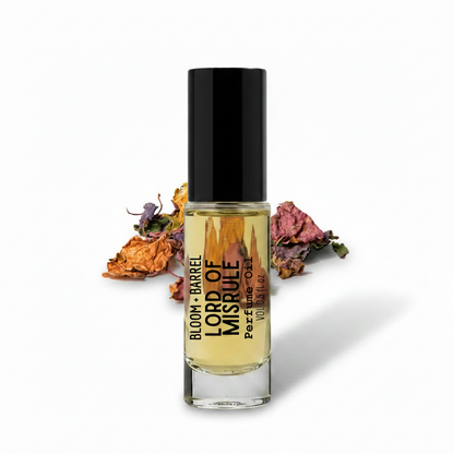 Perfume bottle labeled 'Lord of Misrule' with dried flowers on a white background