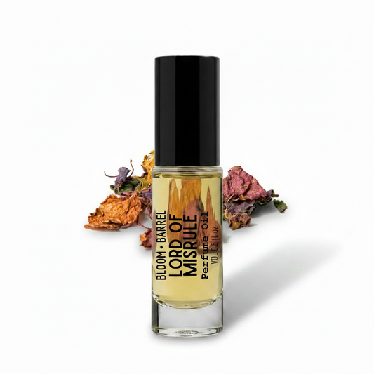 Perfume bottle labeled 'Lord of Misrule' with dried flowers on a white background