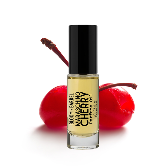 Perfume bottle labeled 'Maraschino Cherry' with cherries on a white background