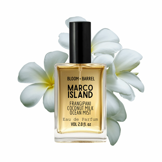 Perfume bottle labeled 'Marco Island' with white flowers on a white background