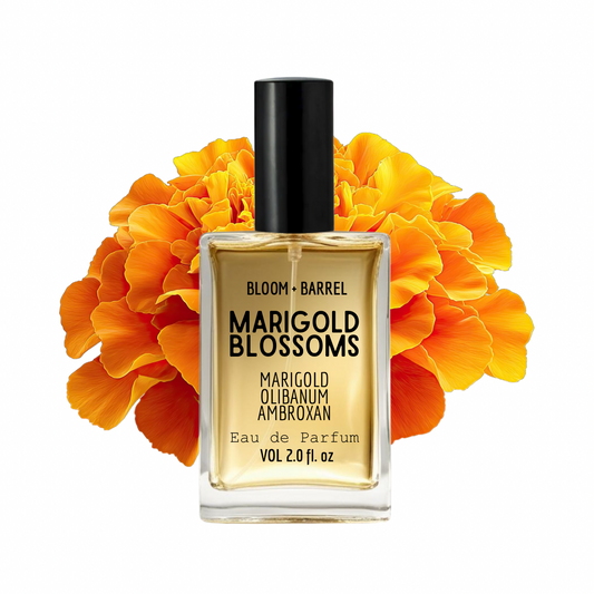 Perfume bottle labeled 'Marigold Blossoms' with marigold flowers on a white background