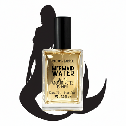 Perfume bottle labeled 'Mermaid Water' with a silhouette of a woman in the background