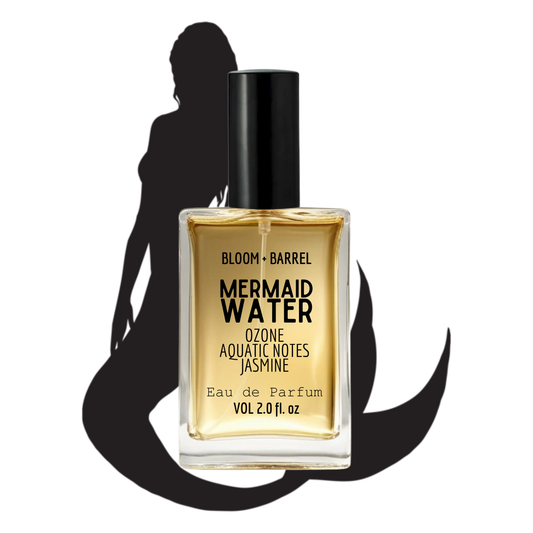 Perfume bottle labeled 'Mermaid Water' with a silhouette of a woman in the background