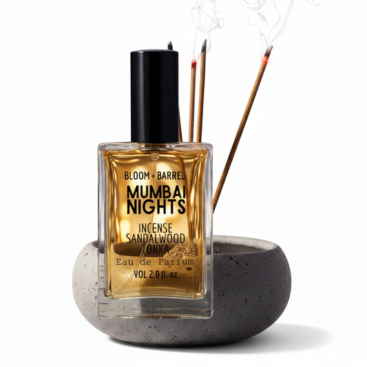 Bottle of Bloom & Barrel Mumbai Nights sandalwood tonka eau de parfum with incense sticks on a white background