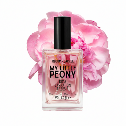 Perfume bottle labeled 'My Little Peony' with pink flowers in the background