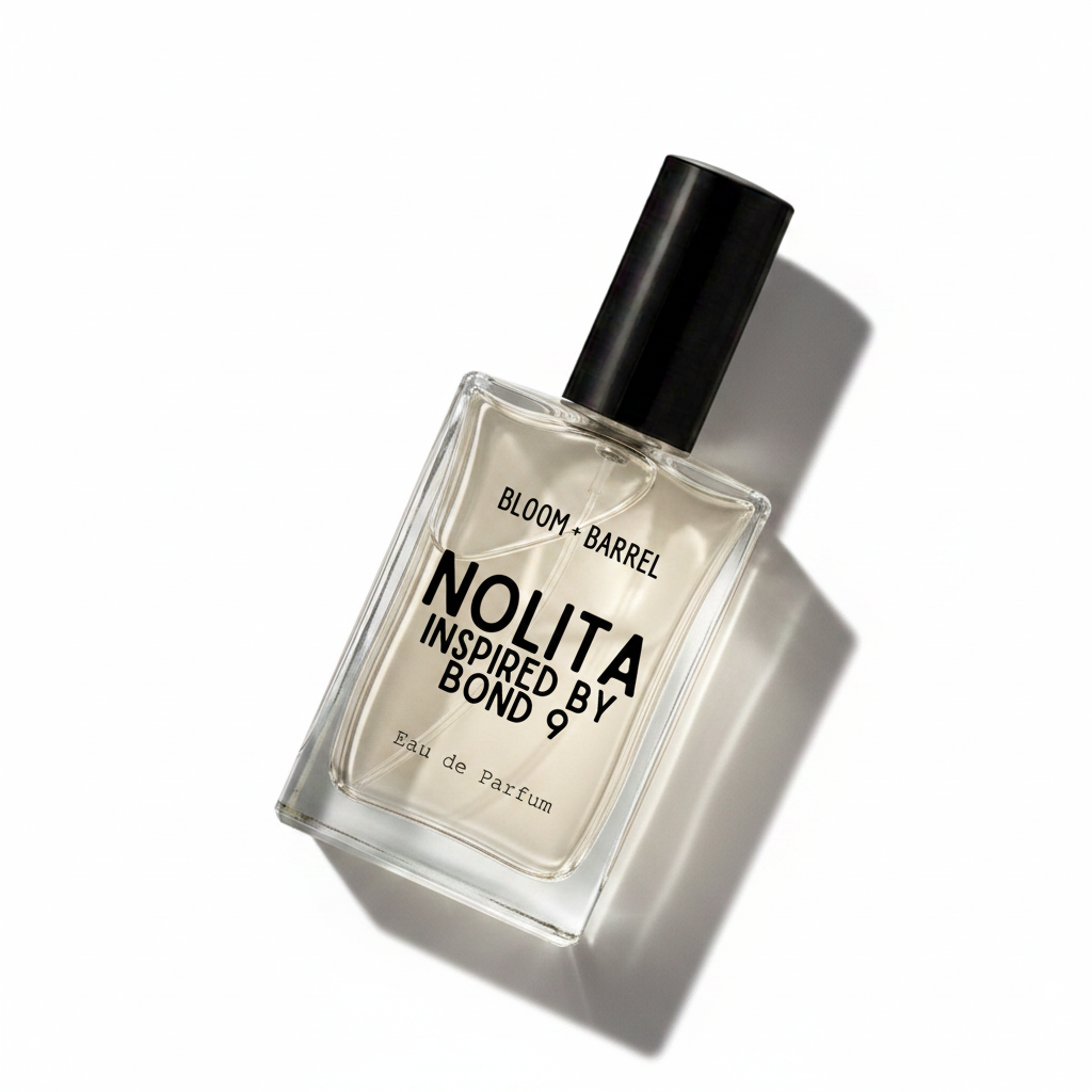 A rectangular glass perfume bottle with a black cap, containing a pale amber liquid. The front label reads 'BLOOM • BARREL' and 'NOLITA INSPIRED BY BOND 9' in black text, with 'Eau de Parfum' at the bottom, on a plain white background.