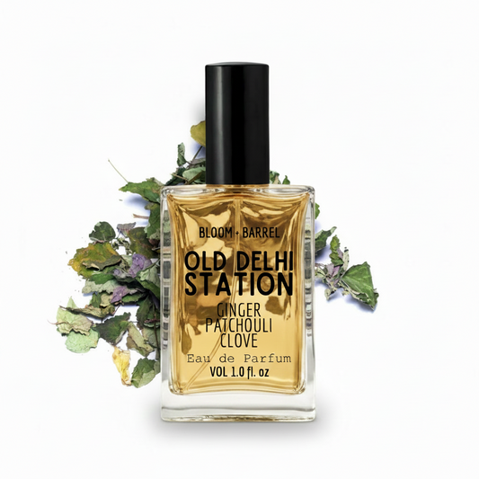 Perfume bottle labeled 'Old Delhi Station' with a black cap on a white background