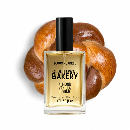 Perfume bottle labeled 'Olde Towne Bakery' with a loaf of bread in the background