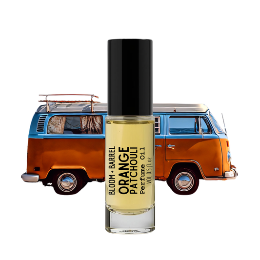 Perfume bottle labeled 'Orange Patchouli' with a vintage van in the background