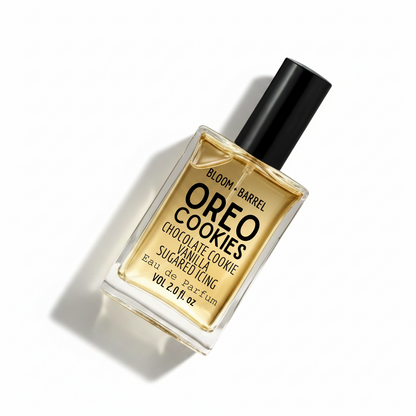 Bloom + Barrel Oreo Cookies Eau de Parfum in a clear rectangular glass bottle with a black cap, filled with golden-amber fragrance, on a white background.