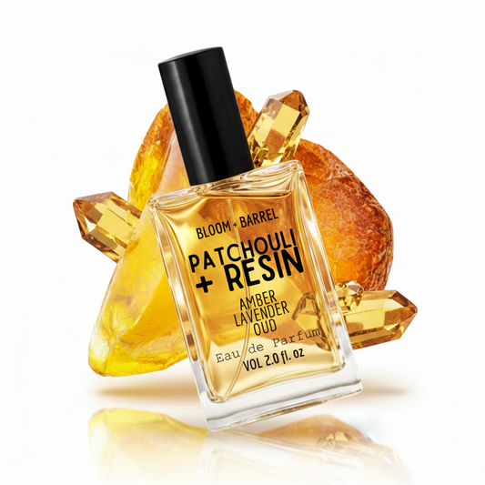 Bottle of Bloom & Barrel Patchouli + Resin Eau de Parfum with amber resin on a white background