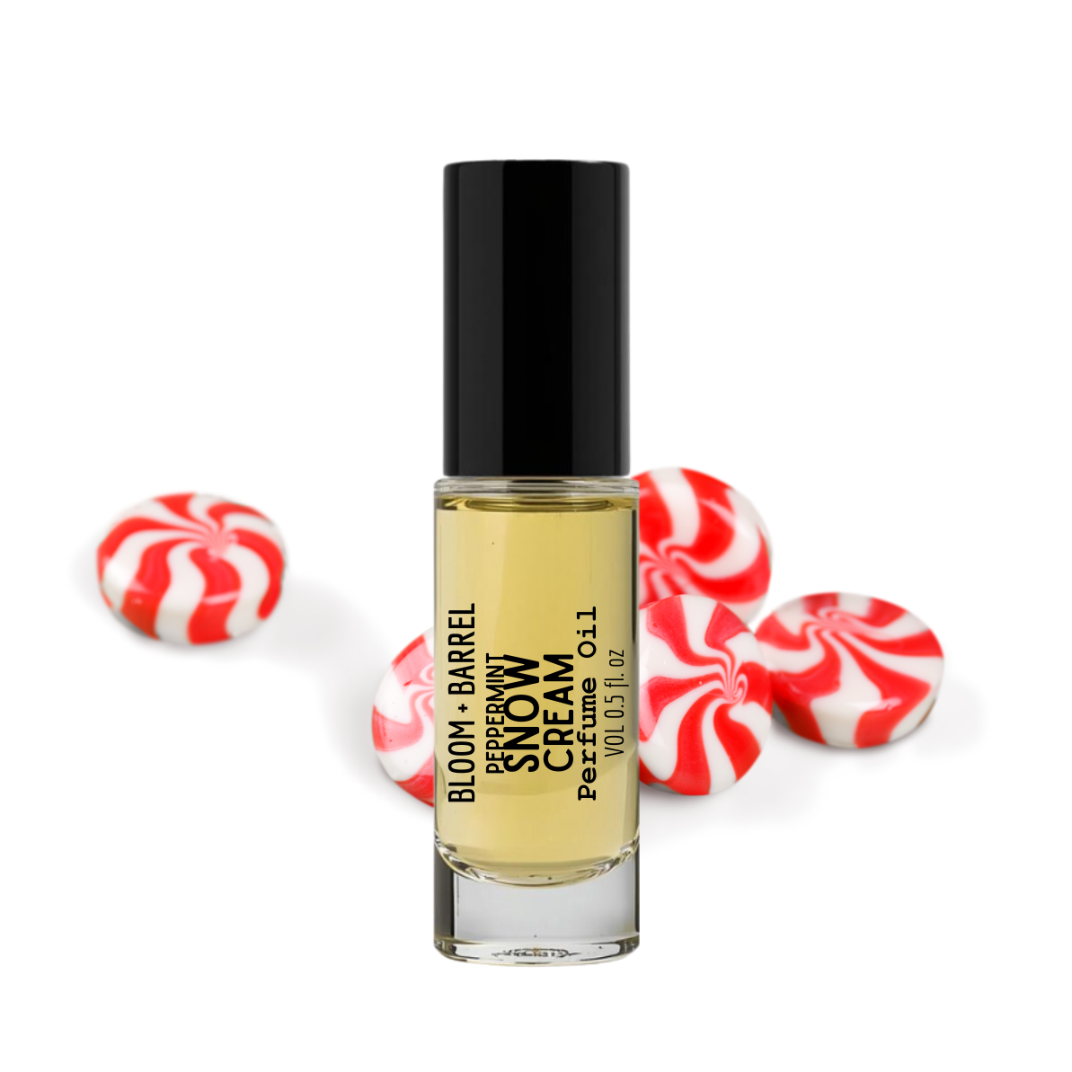 Perfume bottle labeled 'Bloom & Barrel Peppermint Snow Cream' with peppermint candies on a white background