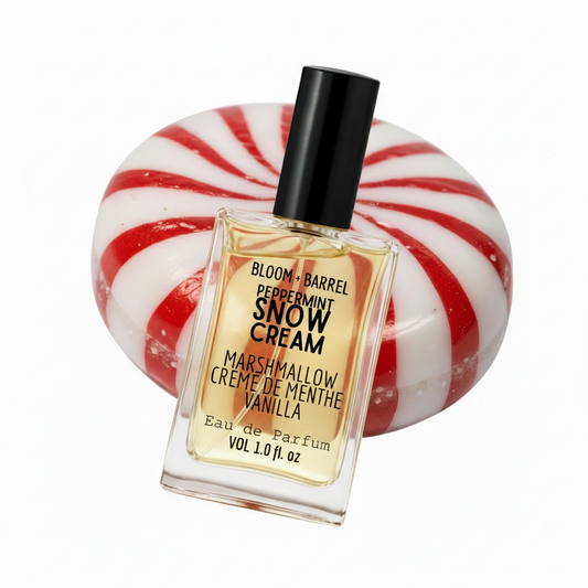 Perfume bottle labeled 'Snow Cream' with a peppermint candy background