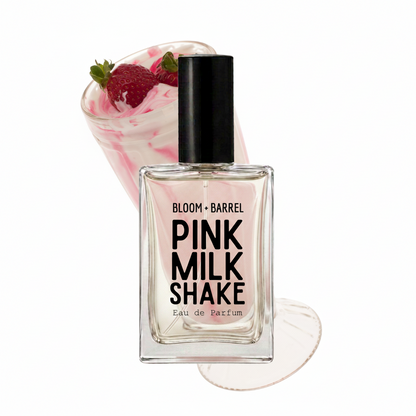 A bottle of Bloom + Barrel Pink Milk Shake Eau de Parfum centered on a white background, with a pink whipped drink and strawberries composited behind it as a styled fragrance concept.