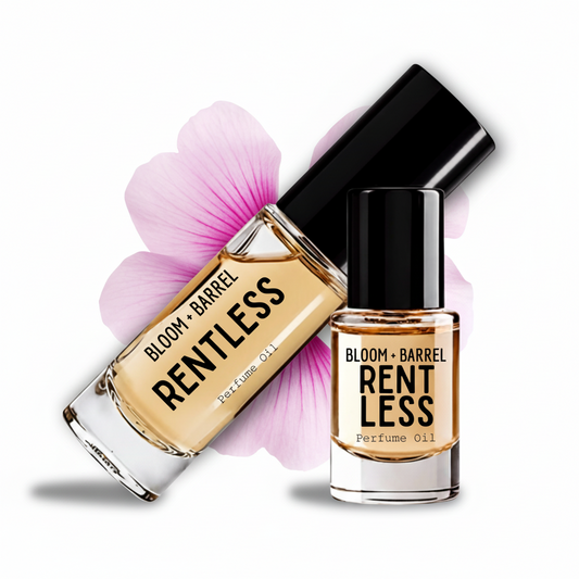 Two glass bottles of BLOOM + BARREL Rentless Perfume Oil with black caps, one upright and one tilted, set against a white background with a pink flower graphic behind them.