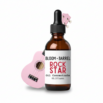 Bottle of Bloom + Barrel Rock Star Oil Concentrate with a pink miniature guitar on a white background