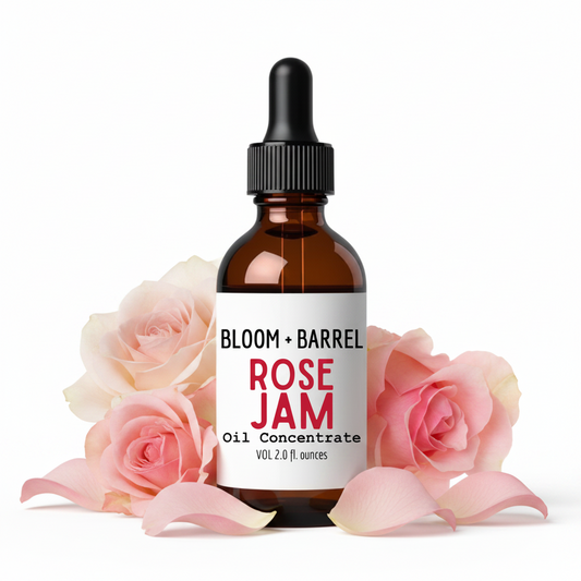 Bottle of Bloom + Barrel Rose Jam Oil Concentrate with pink roses in the background