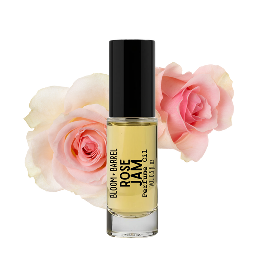 Perfume bottle labeled 'Rose Barrel' with pink roses on a white background