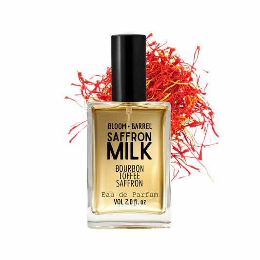 Perfume bottle labeled 'Bloom & Barrel Saffron Milk' with saffron strands on a white background