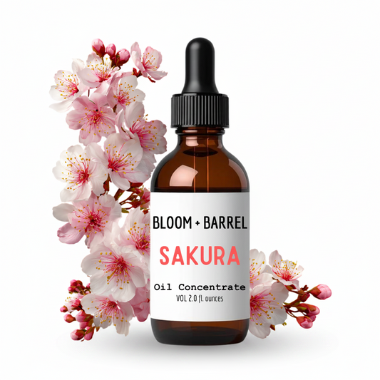 Bottle of Bloom + Barrel Sakura Oil Concentrate with cherry blossoms on a white background