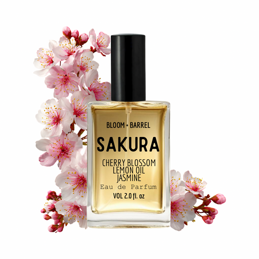 Bottle of Sakura Eau de Parfum with cherry blossoms on a white background