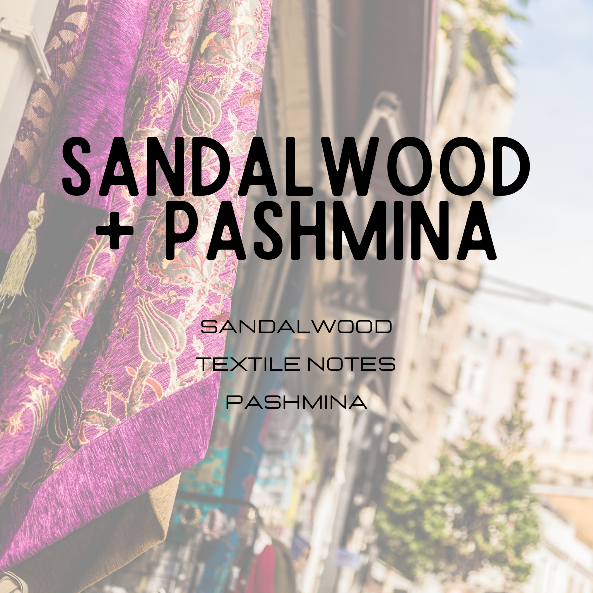 Textile with 'Sandalwood + Pashmina' branding against a blurred cityscape background.