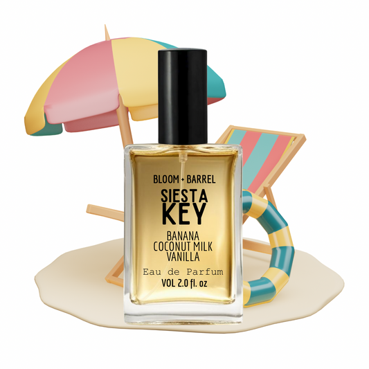 Perfume bottle labeled 'Siesta Key' with a colorful beach umbrella and lounge chair in the background.